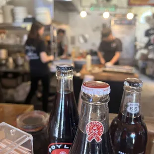 three bottles of soda
