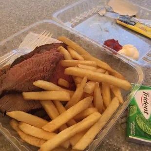 Open faced carved London Broil with side of fries.
