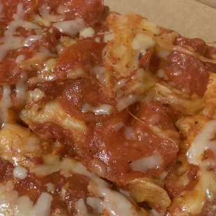 A closeup of this deliciousness of sauce, pepperoni, cheese over an amazing crisp crust!