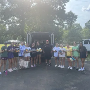 a group of people standing in front of a truck