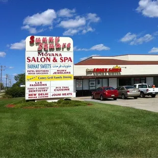 Strip mall sign with Jimmy's Coney in the background.