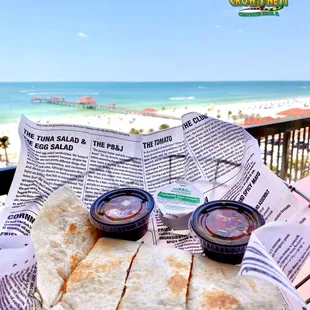 a plate of quesadillas on the beach