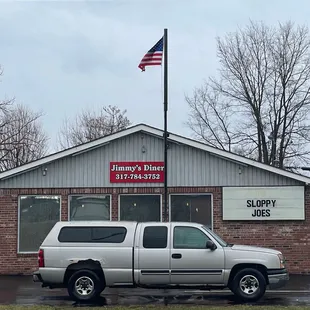 a truck parked in front of a restaurant