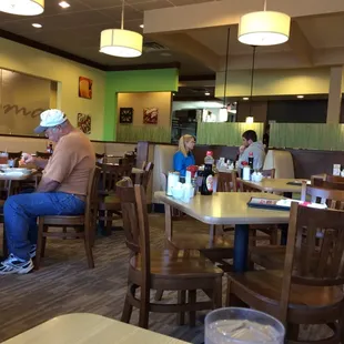 people sitting at tables in a restaurant