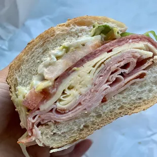 a hand holding a sandwich