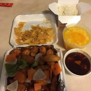 A feast. Sweet and sour chicken with orange chicken sauce instead of sweet and sour sauce. Egg drop soup. Rice. Won ton chips.