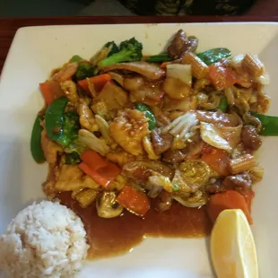 This dish is called happy family it's a combination of chicken beef pork and shrimp with fried rice and vegetables