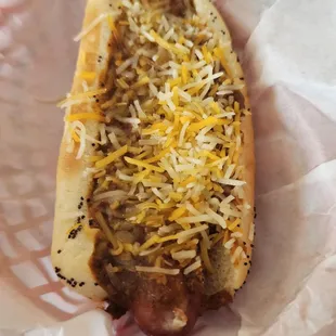a hot dog covered in cheese