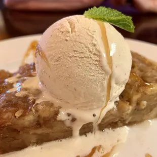 Homemade cinnamon bread pudding served warm with vanilla bean ice cream