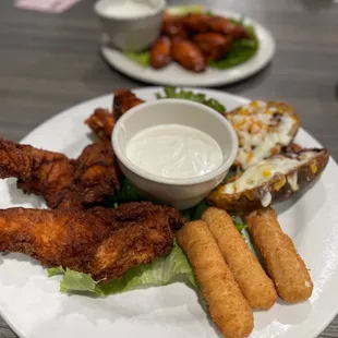 a plate of fried chicken with dipping sauce