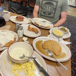 Pancakes, chicken fried steak, Mac and cheese, green beans, grits and eggs, chicken strip and small piece of meatloaf.