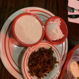 a plate of food and a bowl of dips