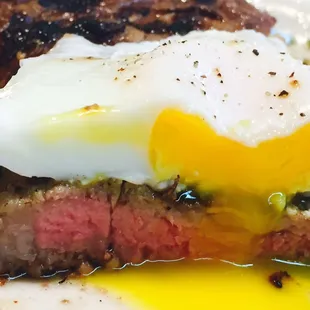 Medium rare Rib Eye with poached egg on top. Ate the steam veggies and salad already. Cutting the egg and steak together surprised me.
