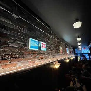 Retro beer regalia lines the brick, classically decorated.