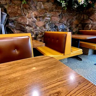 tables and booths with flowers on the wall