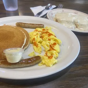 Short stack pancakes with two eggs and two sausage. Half order biscuit and gravy.