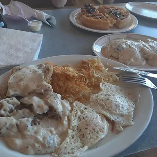Biscuits and gravy, chicken fried steak, eggs over medium, hash browns extra crispy. Belgian waffle with chocolate chips.
