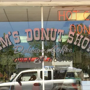 a truck parked in front of a donut shop