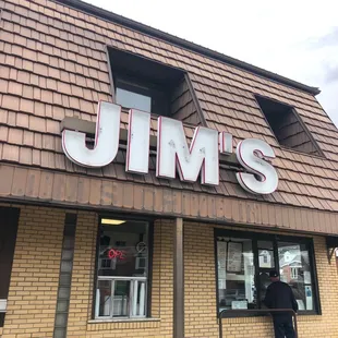 a man standing outside of a restaurant