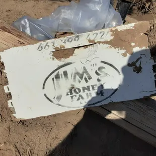 I found this sign, or possibly part of a crate, in the Ventura River about 1/2 mile from the Pacific Ocean.  I wonder if they want it back?