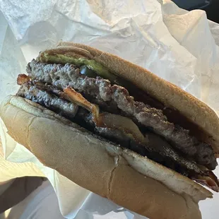 a hand holding a sandwich