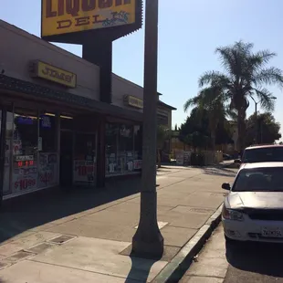 a car parked in front of a liquor store