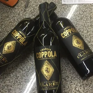 three bottles of wine on a counter