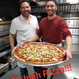 Owner Jim with son Anthony and the big 28" Pizza! DINE-IN only because they don't make a box big enough!!!