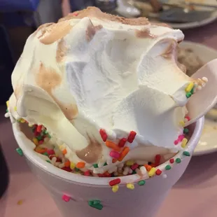 A giant chocolate and vanilla swirled ice cream in a cup.