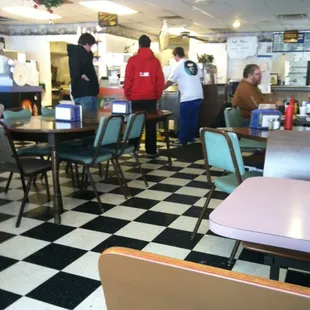 diners in a restaurant with checkered floor