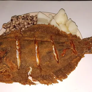 Whole fresh flounder fried with black eye peas and boiled potatoes.