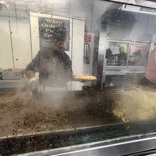 a man and a woman cooking food