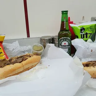 two subs and a bottle of beer