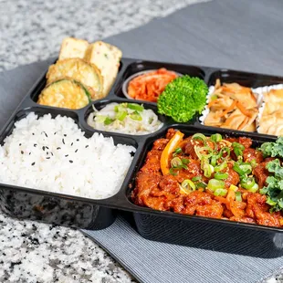 a tray of rice and vegetables