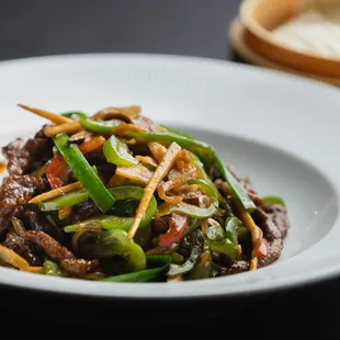 Hot Chili Pepper Beef - Wok smoked beef stir fried with Julienne cut peppers and veggies. Served w/ fresh steamed rose bun.