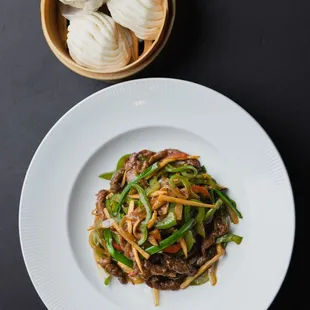 Man Tou, or steamed Chinese bao - a soft, fluffy, and slightly sweet steamed bread that is perfect to pair with stir fry.