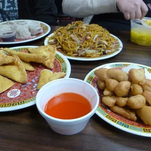 (Clockwise from top left) Dumplings, Lo Mein, Wonton Soup, Sweet and Sour Chicken, Crab Ragoon