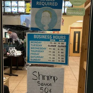 a business hours sign in a restaurant