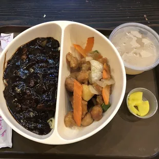 24. Korean black bean pork noodles and pineapple chicken combo