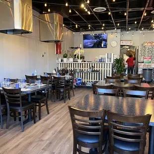 the interior of a restaurant with tables and chairs