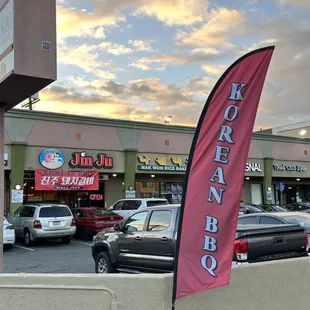 Flag banner on Western ave. that reads &quot;KOREAN BBQ&quot; in english