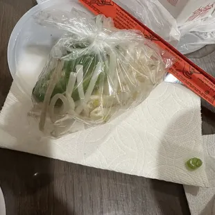 a bag of noodles and a chopstick