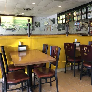 a dining area with yellow walls