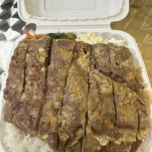 Meat jun with kimchi cucumber, potato salad, japchae, and mac salad