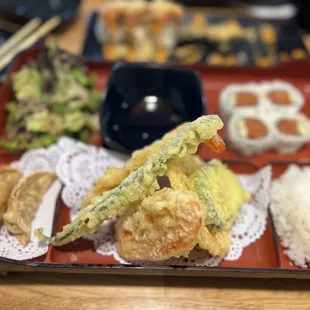 Lunch bento, tempura, spicy tuna roll and a hot night roll in the back