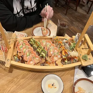 a person in a boat with sushi on it