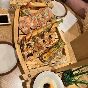 a wooden boat filled with sushi