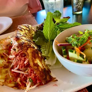 Thai Crepe (Kanom Buang) Crispy crepes stuff with spiced tofu, coconut flakes, shrimp, bean sprouts, and a side of cucumber salad.