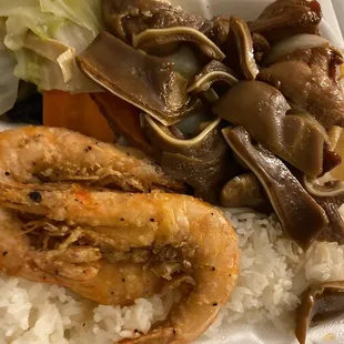 a take out container with rice, shrimp, and vegetables