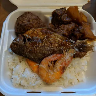 Lunch box - spare ribs, meatballs, fried fish, and fried shrimp. Slightly under seasoned and bland